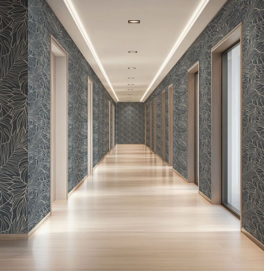 A hotel hallway with Covr’s botanical Paradiso Wallpaper in Celestial, light wood floors, multiple side doorways, and recessed ceiling lights.