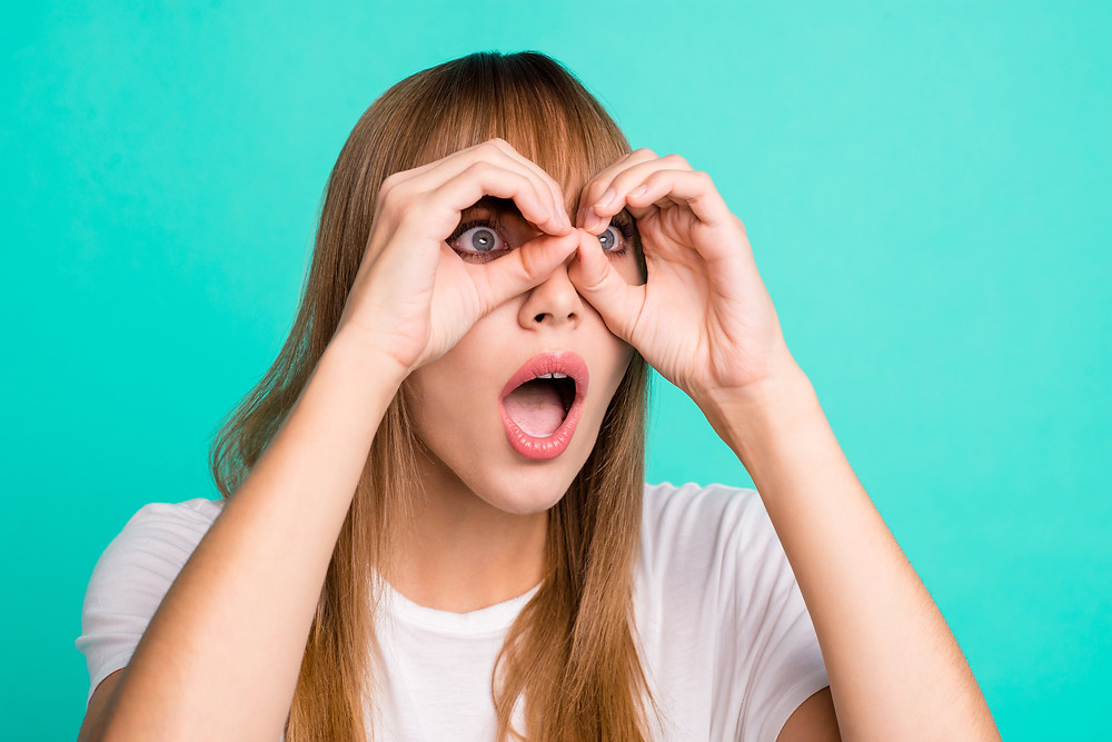 Girl using her hands as binoculars.