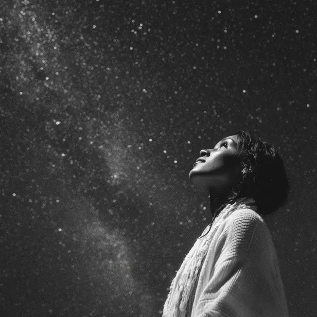 a woman looking up at a futuristic galaxy