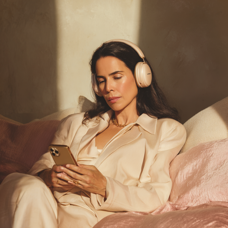 woman with iPhone and headphones relaxing