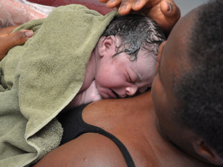 New born baby on birthing person's chest