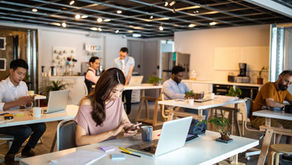 Autistic employees in open office workspace facing distractions and support gaps at work daily.