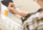 autistic adult writing her tasks in her notebook