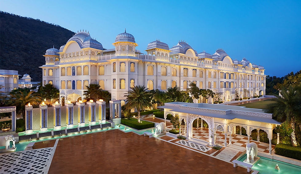 The Leela Palace Jaipur stands majestically against a serene evening sky.