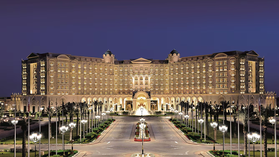 The Ritz-Carlton hotel stands majestically under the evening sky, its grand facade illuminated brilliantly.