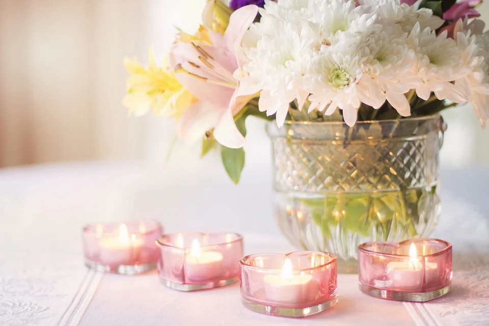 Centerpiece with white flowers and candles in hearth shaped containers