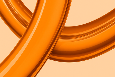 a close up of two orange rings on a white background