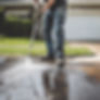 Person power washing a driveway .jpg