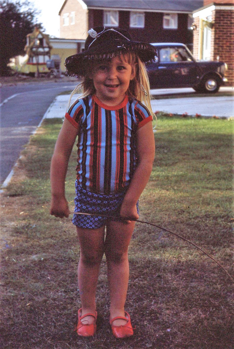 Sally dressed in cowboy hat and red shoes