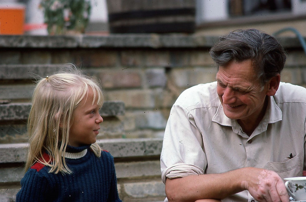 Julia and Granpop in the garden with cup of tea