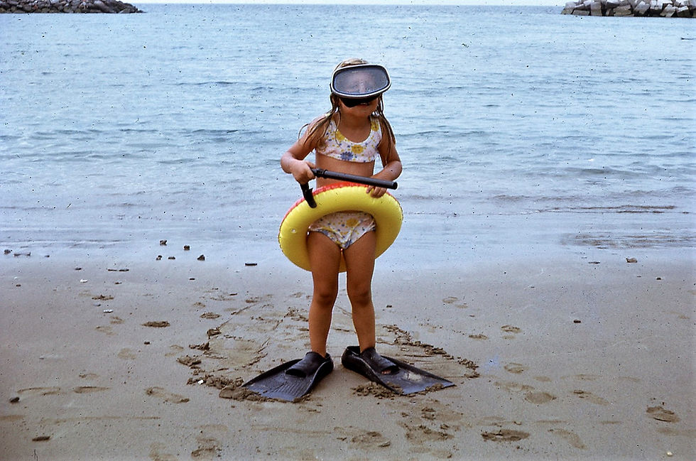 Sally on the beach with mask and flippers
