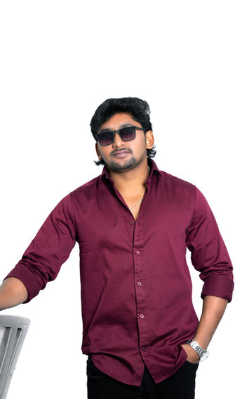 Man wearing sunglasses, maroon shirt, and leaning, with a white background.