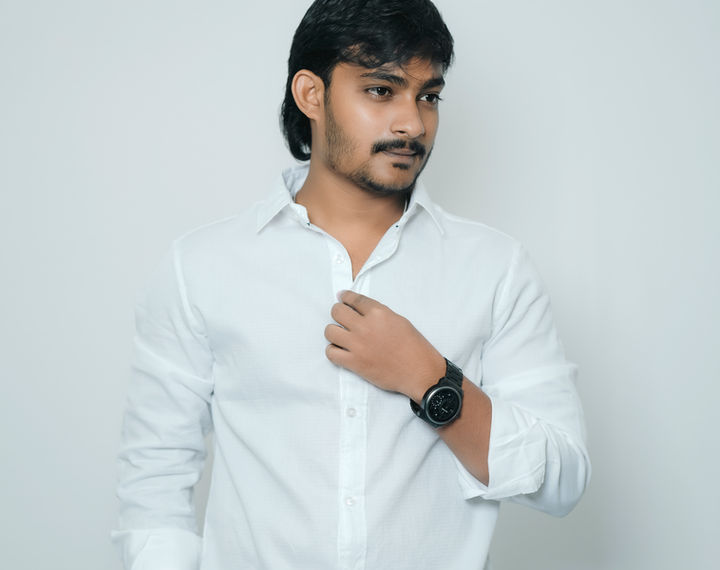 Man in white shirt and black pants, posing for a shot. lunexwear