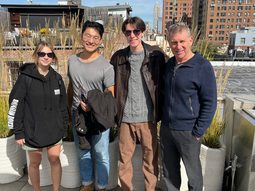 A photograph of Principal Adam Kushner and a few of his interns (past and present) standing at his 16 Minetta Lane home.