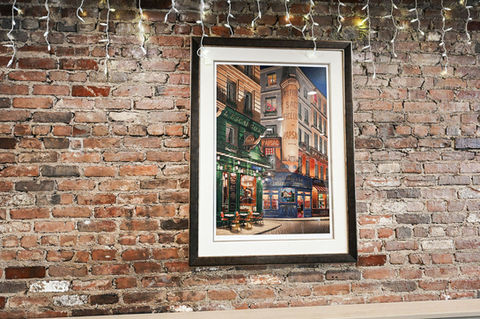 Picture of a framed cafe painting on brick wall; Ball Square Cafe.