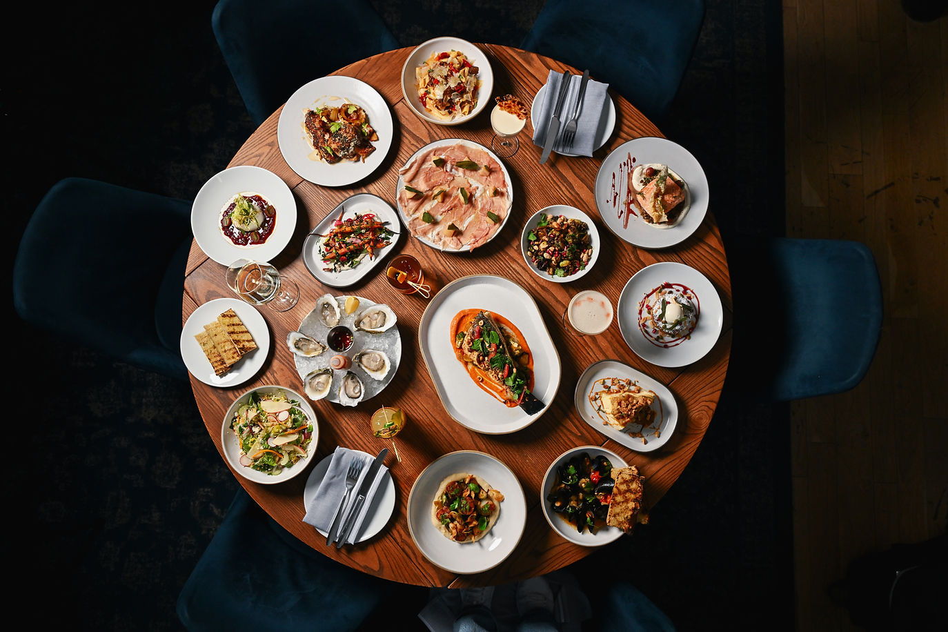Overhead view of various dishes on a round table, Porto Boston restaurant.