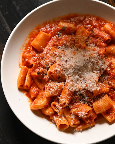 Rigatoni pasta tossed in red sauce topped with parmesan cheese