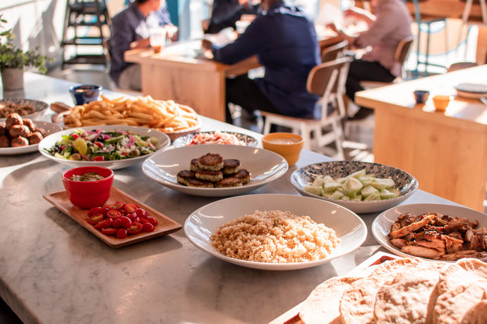 A marble counter top with assorted dishes plated on top.