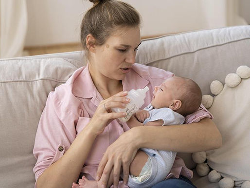 Parent bottle feeding a baby experiencing possible silent reflux symptoms