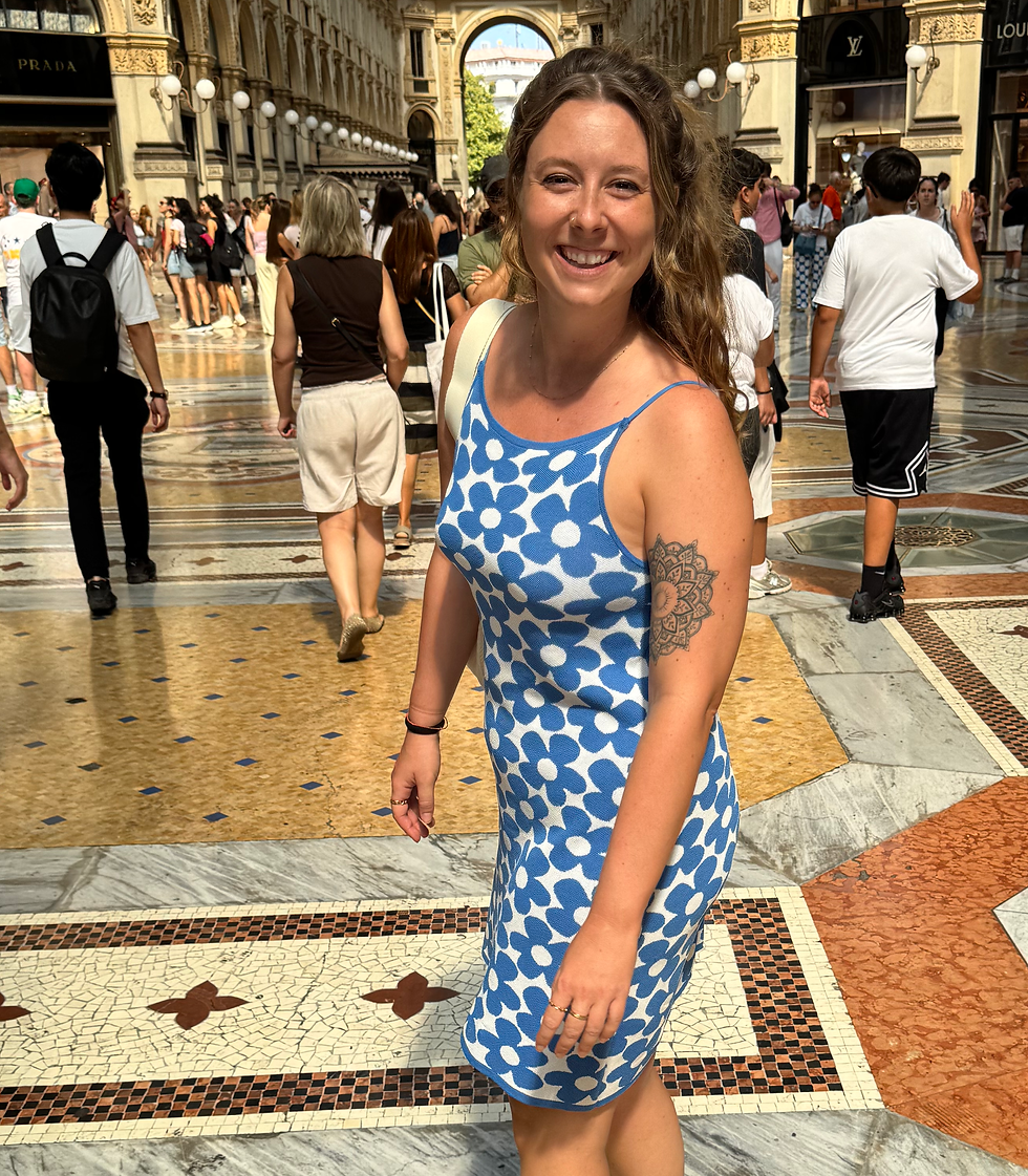 Dizzie smiling in a blue dress in Milan
