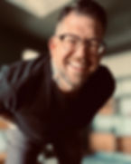 Jason Heisserer smiling at the camera with glasses.