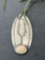 Hand-stamped maker's mark on polished silver oval, Southwest artisan jewelry