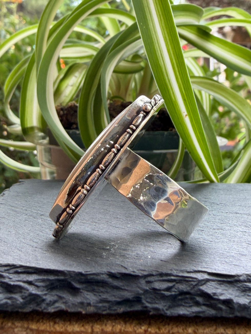 Hammered sterling silver band beneath blush jasper stone, Southwest artisan jewelry