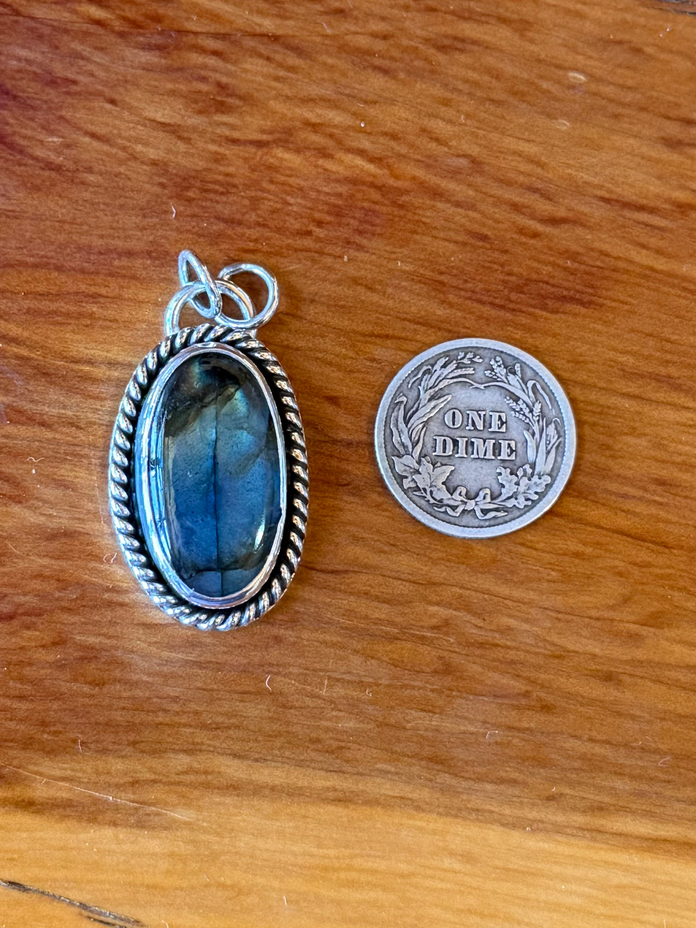 Deep electric blue flash labradorite oval pendant, twisted rope border, oxidized finish, handcrafted Taos, New Mexico