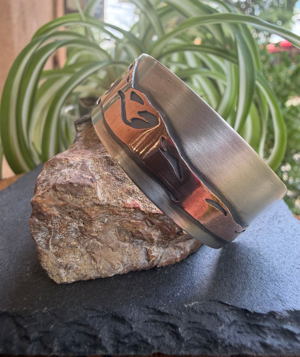 Taos mountain cuff shown in profile, copper overlay depth visible, Southwest artisan jewelry