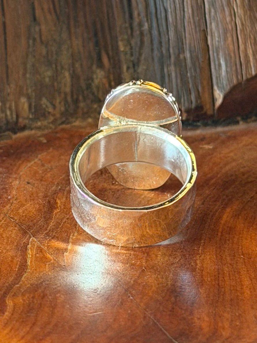 Hammered sterling silver band beneath oval turquoise stone, Southwest artisan jewelry