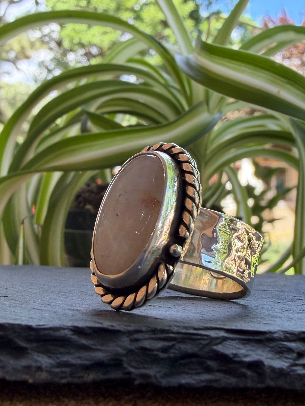Hammered sterling silver band beneath moonstone cabochon, Southwest artisan jewelry