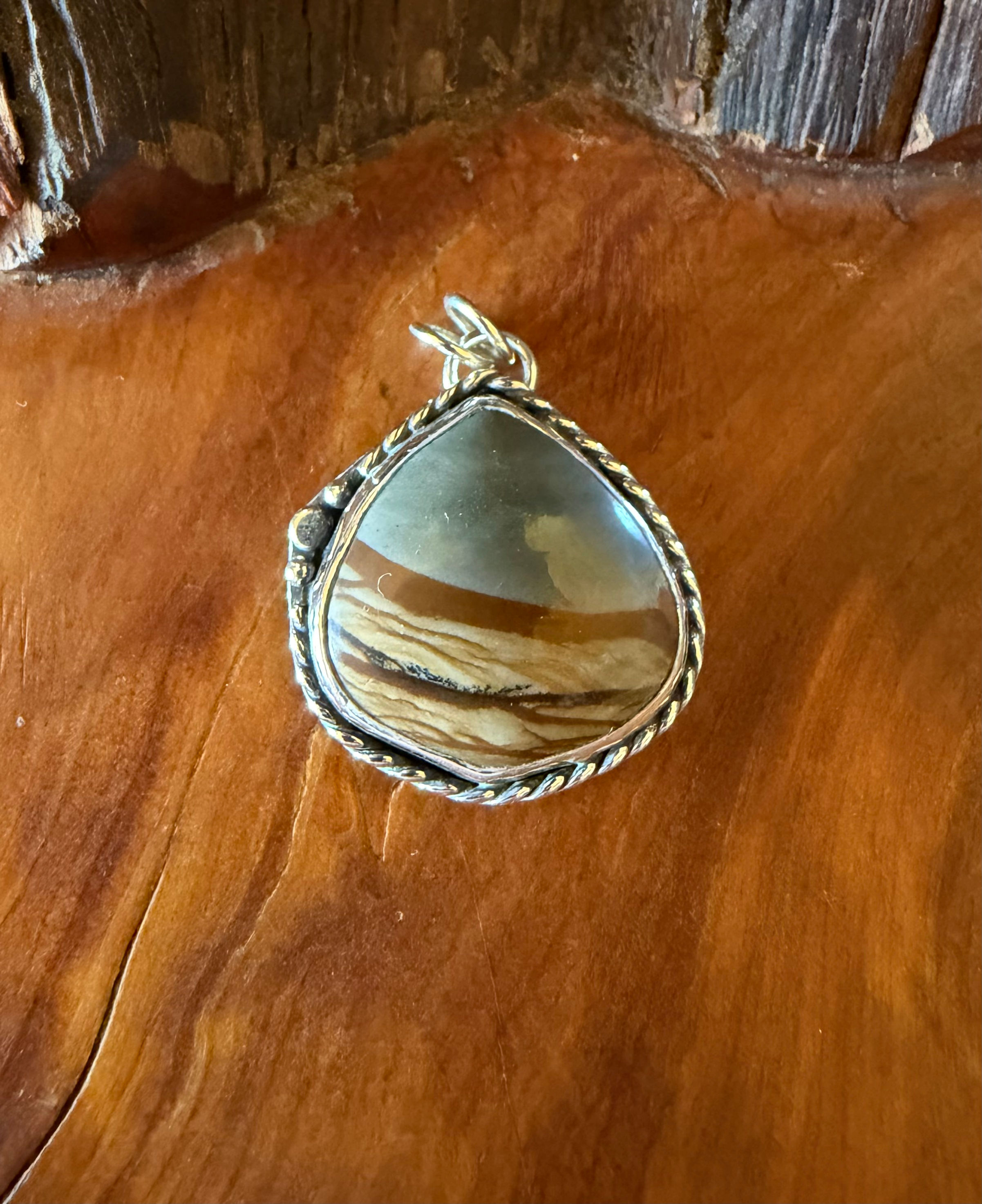 Oregon Owyhee jasper freeform pendant, pale blue grey ochre banding, twisted rope border, handcrafted Taos, New Mexico