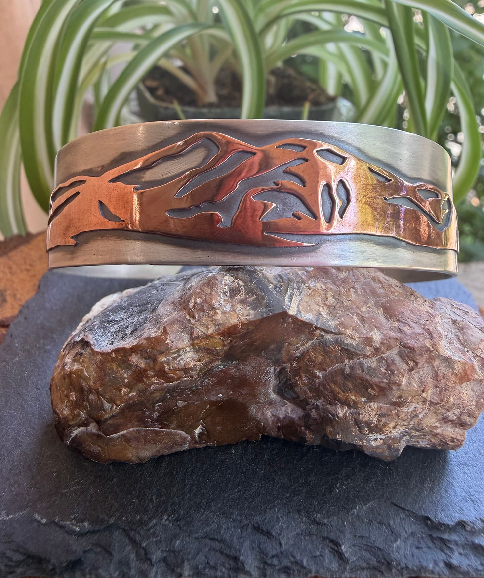 Hand-sawn Taos mountain silhouette cuff in copper and 18-gauge silver, handcrafted in Taos, New Mexico