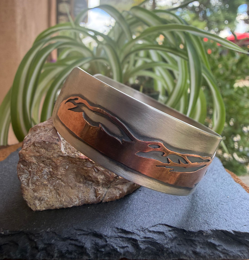 Taos mountain cuff shown in profile, copper overlay depth visible, Southwest artisan jewelry
