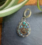 Back of ammonite earrings showing hand-stamped maker's mark, Southwest artisan jewelry, Fire & Stone