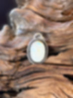 Rainbow moonstone oval pendant, blue flash adularescence, twisted rope border, oxidized finish, handcrafted Taos, New Mexico
