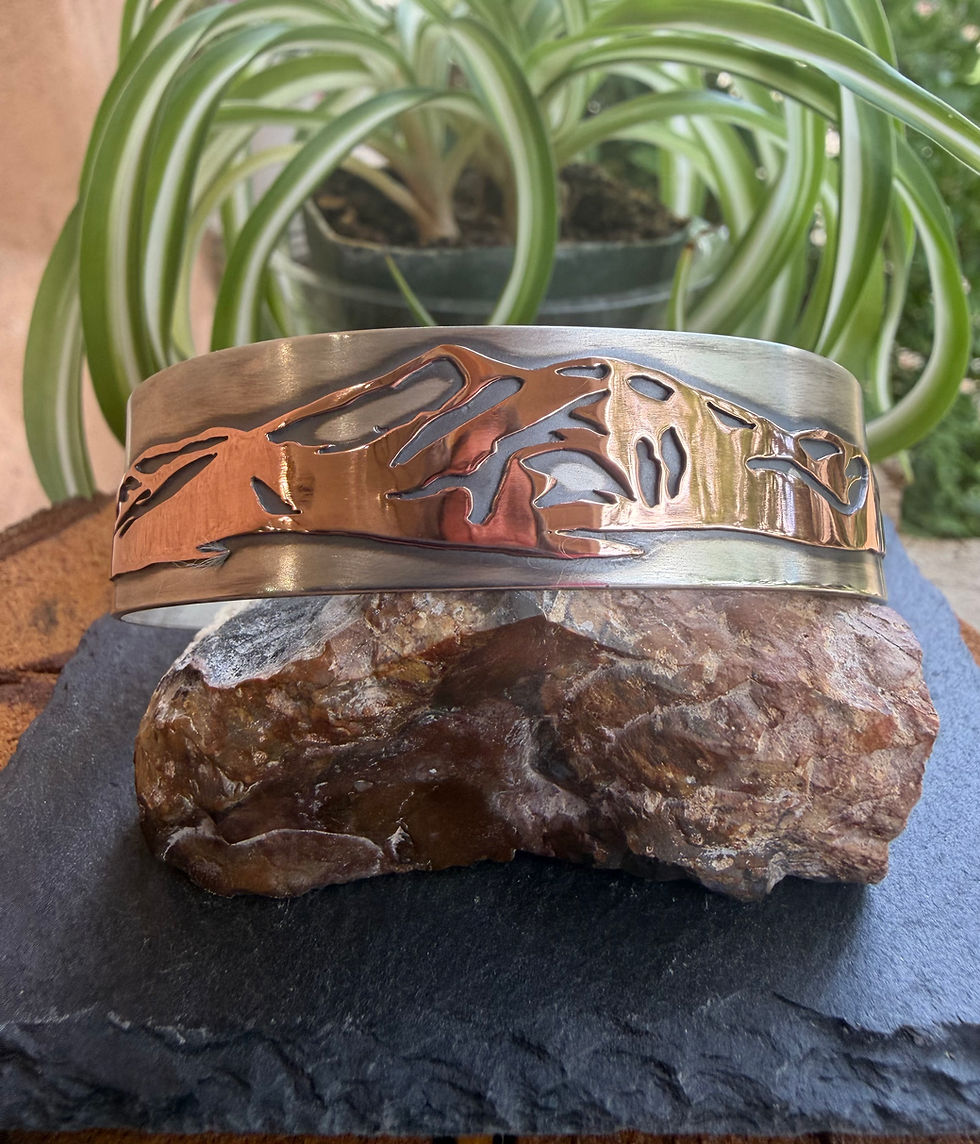 Hand-sawn Taos mountain silhouette cuff in copper and sterling silver, handcrafted in Taos, New Mexico