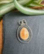 Elk ivory pendant in double rope-twist halo, handcrafted Taos, New Mexico