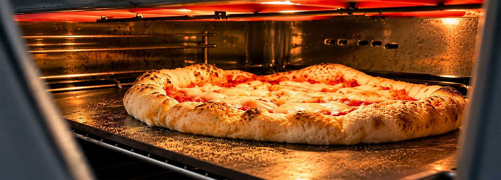 Cheese pizza baking in a glowing oven, with a browned crust on a baking steel and warm orange light.