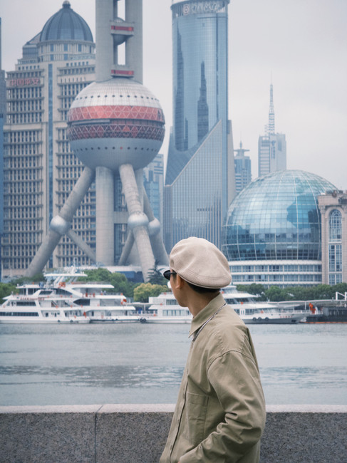 Man posing infront of Oriental Pearl Tower in Shanghai China.