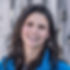Sidney Wilder - a smiling woman with long dark hair wearing a blue jacket.