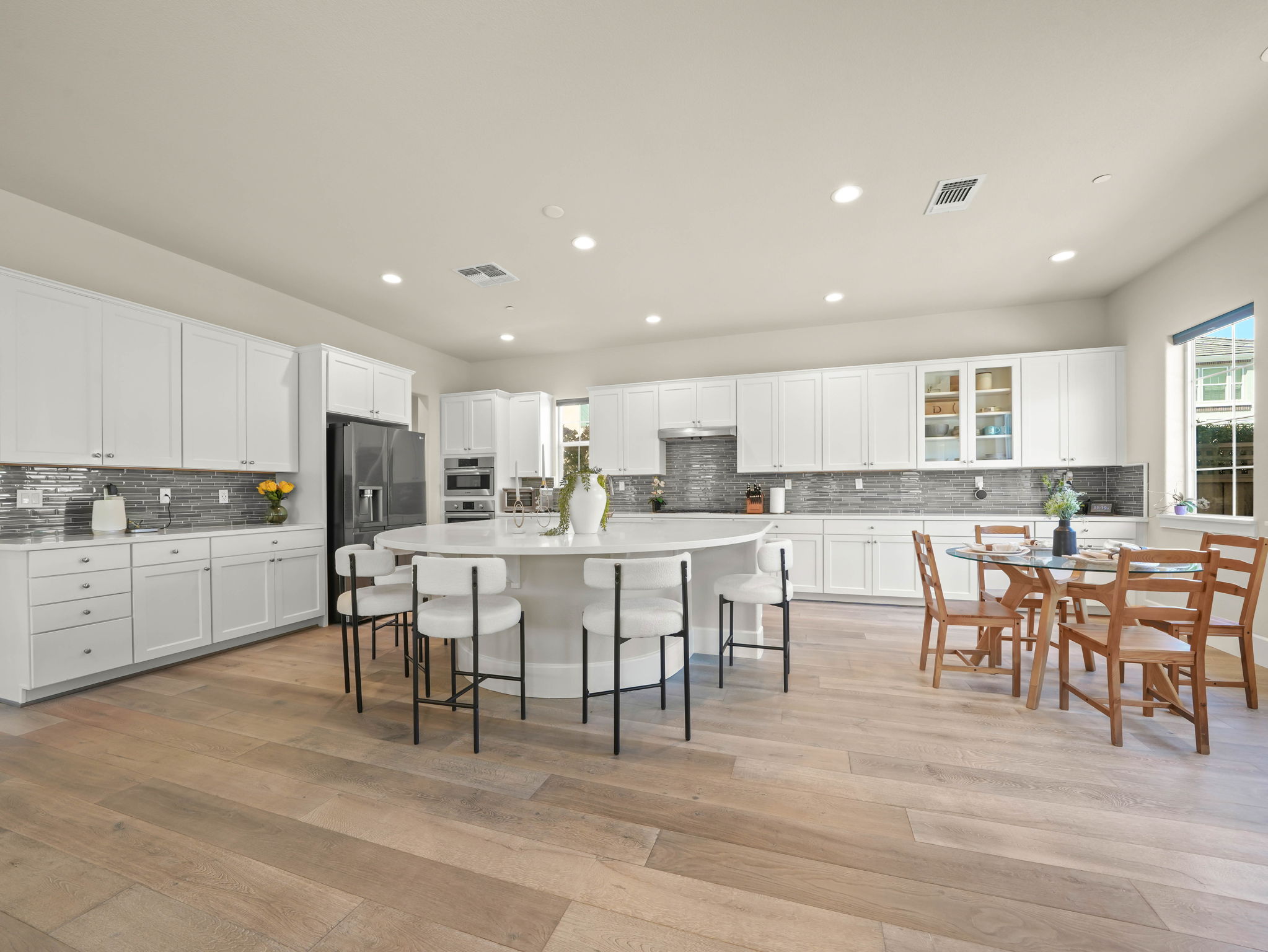 A bright and airy gourmet kitchen showcasing premium finishes and an open concept design.