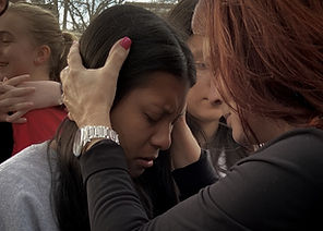 Pastor Cathy Sellstrom praying for a woman