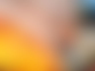 Firefighter with hose spraying with active fire in the background