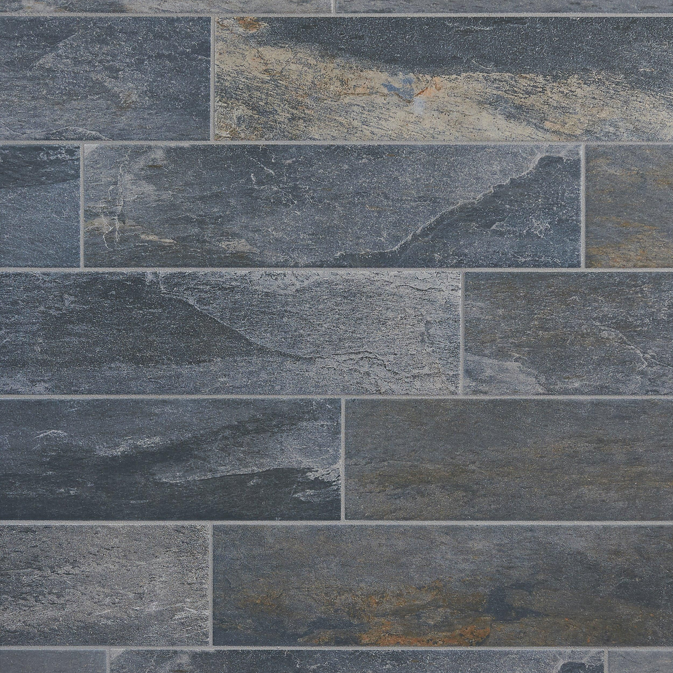 Close-up of a textured slate tile wall with varying shades of gray, blue, and hints of rusty orange, arranged in a staggered pattern.