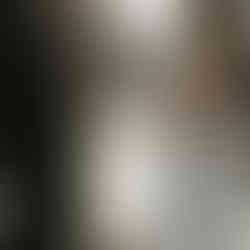 A bride and groom share an intimate moment on a bridge over a sunlit canal in Venice, representing a dream destination wedding or honeymoon in Italy.