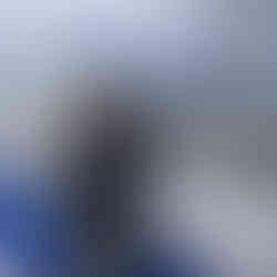 Claire Oliver, Owner of Luxury Dream Holidays, on a ferry to Saaremaa Island in Estonia. She is looking through binoculars on the deck of the ferry.