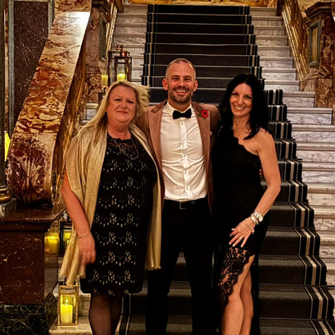 Luxury Dream Holidays founders with LUSSO representative at Luminari Awards 2025 black tie ceremony London