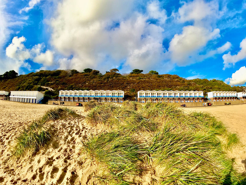 Bournemouth Beach, with its iconic row of brightly coloured beach huts, serves as a stunning backdrop for Dorset Rough Riders' beachside cycling adventures, offering a perfect combination of challenging rides and relaxation.