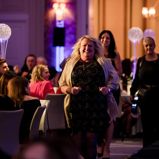 Claire walking to stage to accept Best New Agency award at LUSSO Luminari Awards 2025 Kimpton Fitzroy London